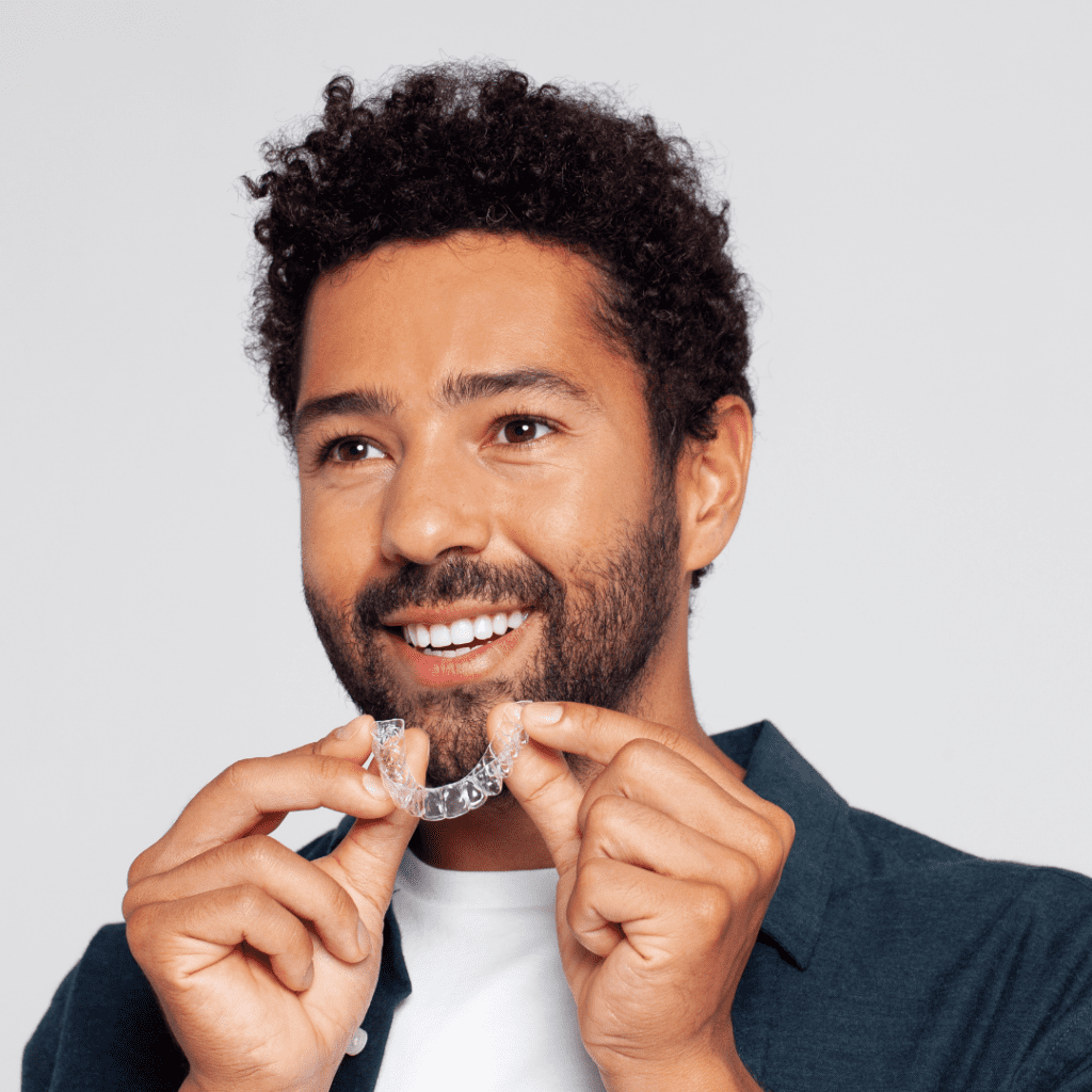 Man putting in his reveal clear aligners